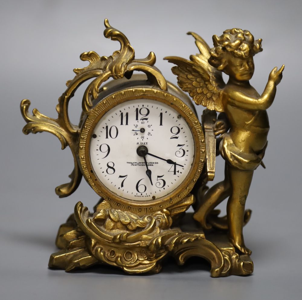 An American ormolu timepiece, New Haven Clock Co., movement in rococo style case with cherub surmount, 16cm high